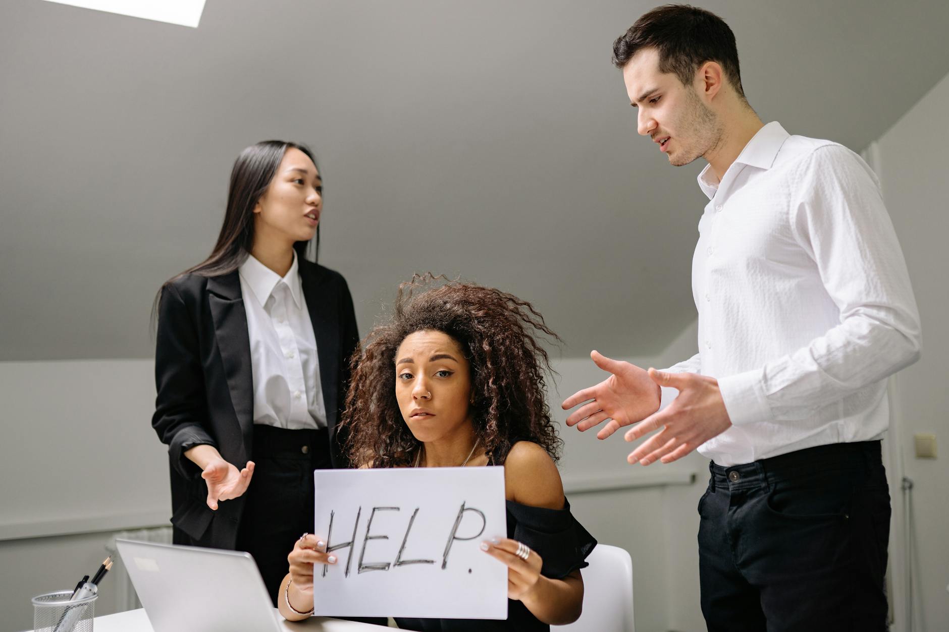 a bullied woman holding a paper with help sign